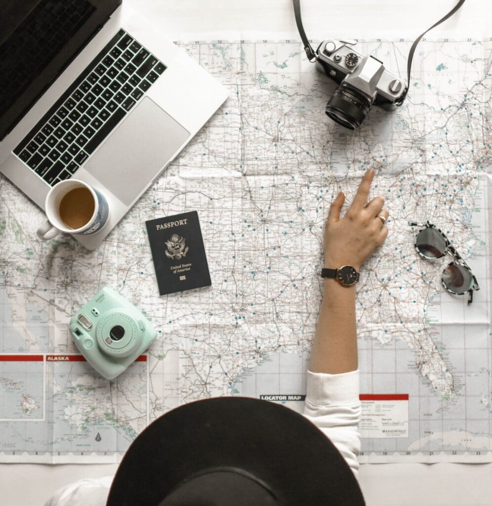 Culture-focused travel improves key life skills. A traveler has a map and a laptop out to plan the next life-changing experience 