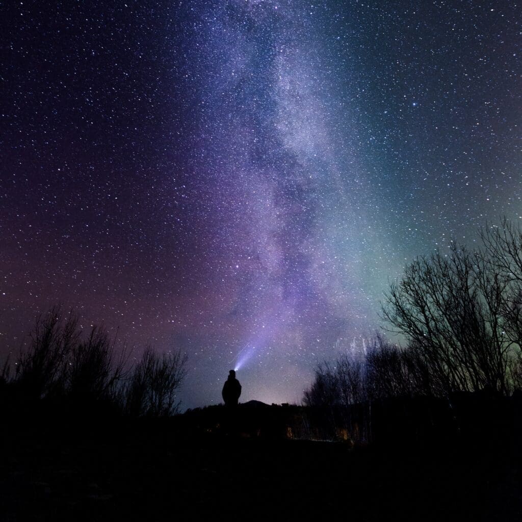 Staring into space 2 • Worldly-Minded A human stares into the night sky contemplating life's origins. To reset your mind, we have to accept the absolute truth that no one knows the answer to how we began.