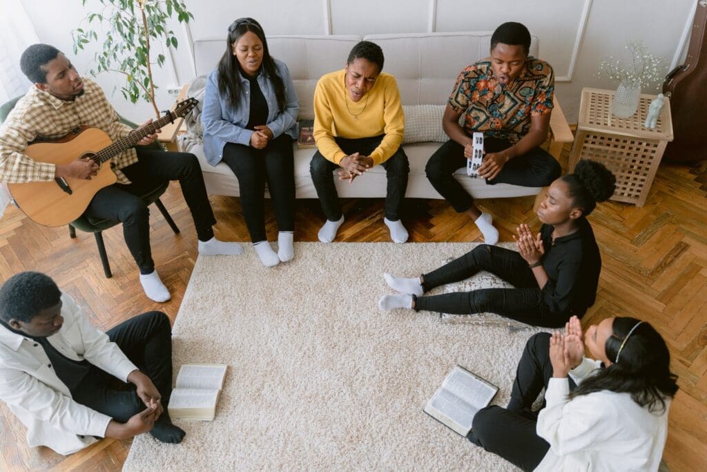 A group of individuals gather around for a religious study. Although religious faith is globally declining, there are some positives attributes to this lifestyle