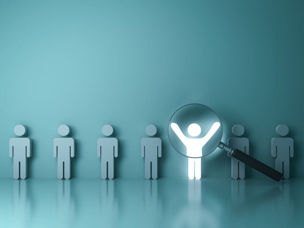 Searching for the right person concept Stand out from the crowd and different concept Magnifying glass focusing on the light man standing with arms wide open on green wall background 3D rendering • Worldly-Minded A person shines out in the crowd. After deconstruction we can mentally rebuild with no limitations